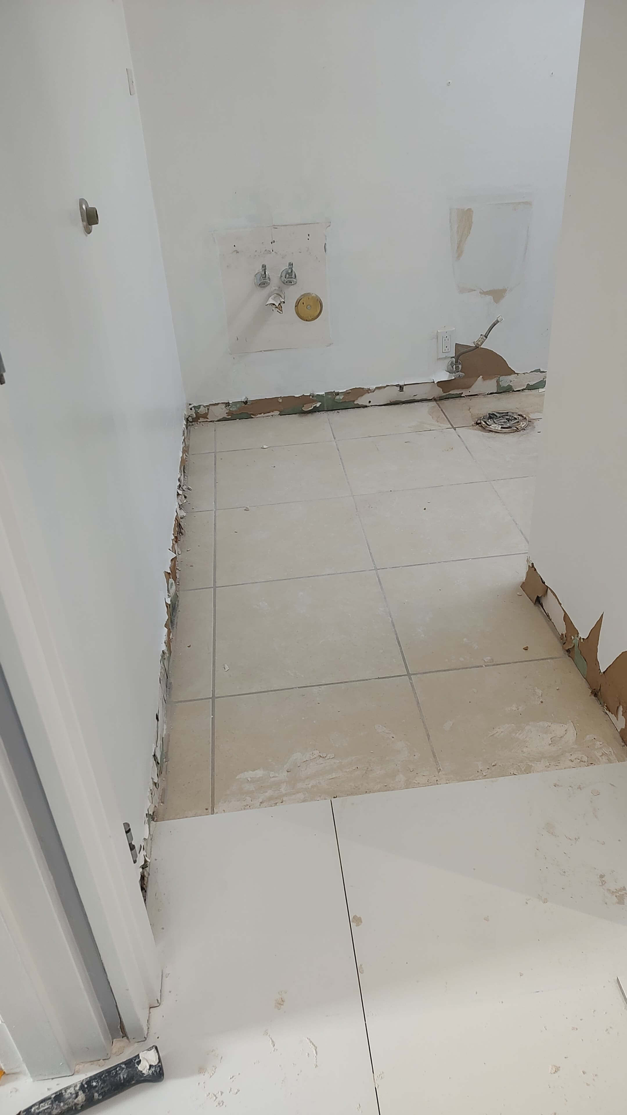 Bathroom stripped down to subfloor and rough plumbing before remodel