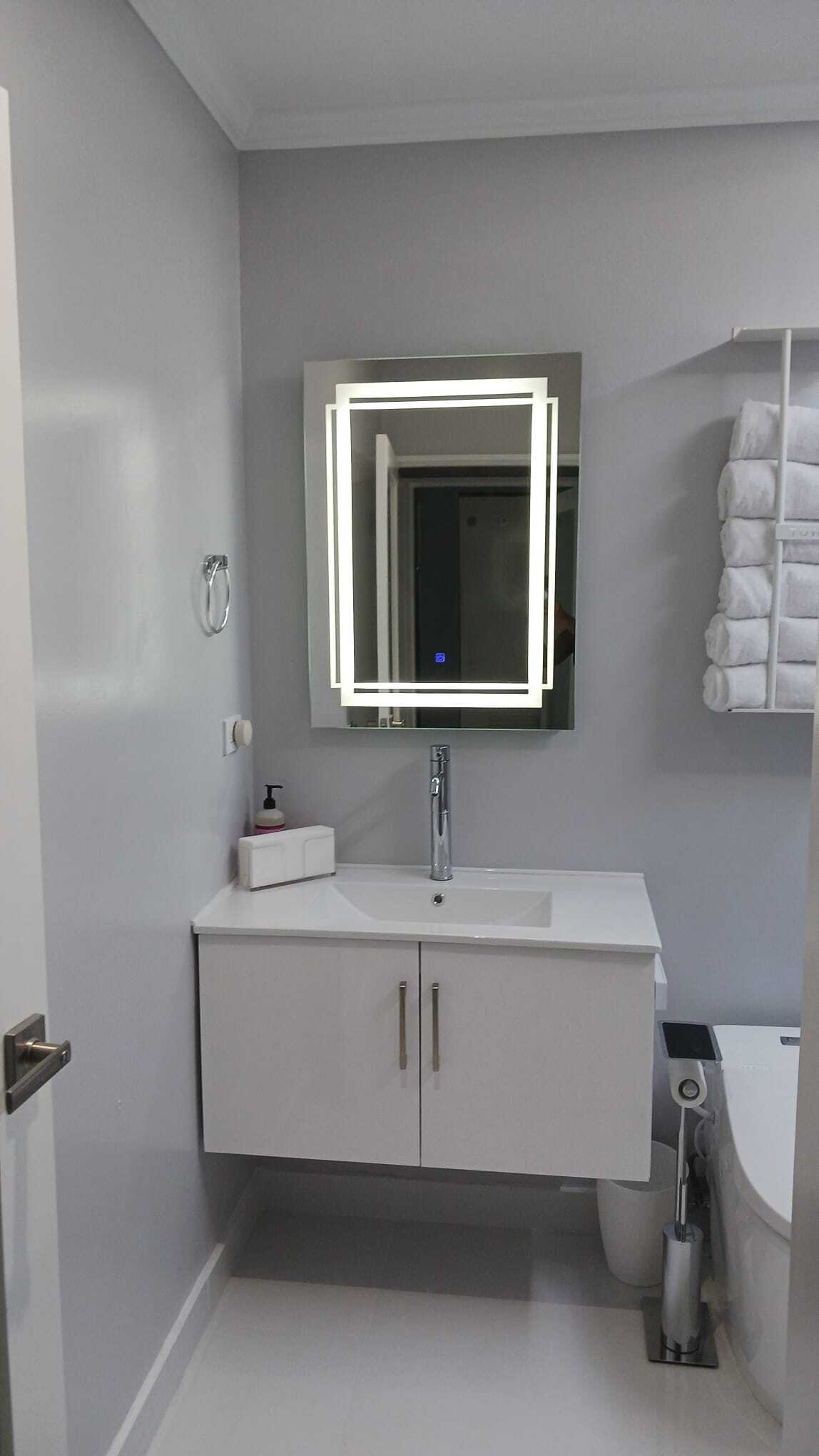Bathroom vanity with backlit LED mirror