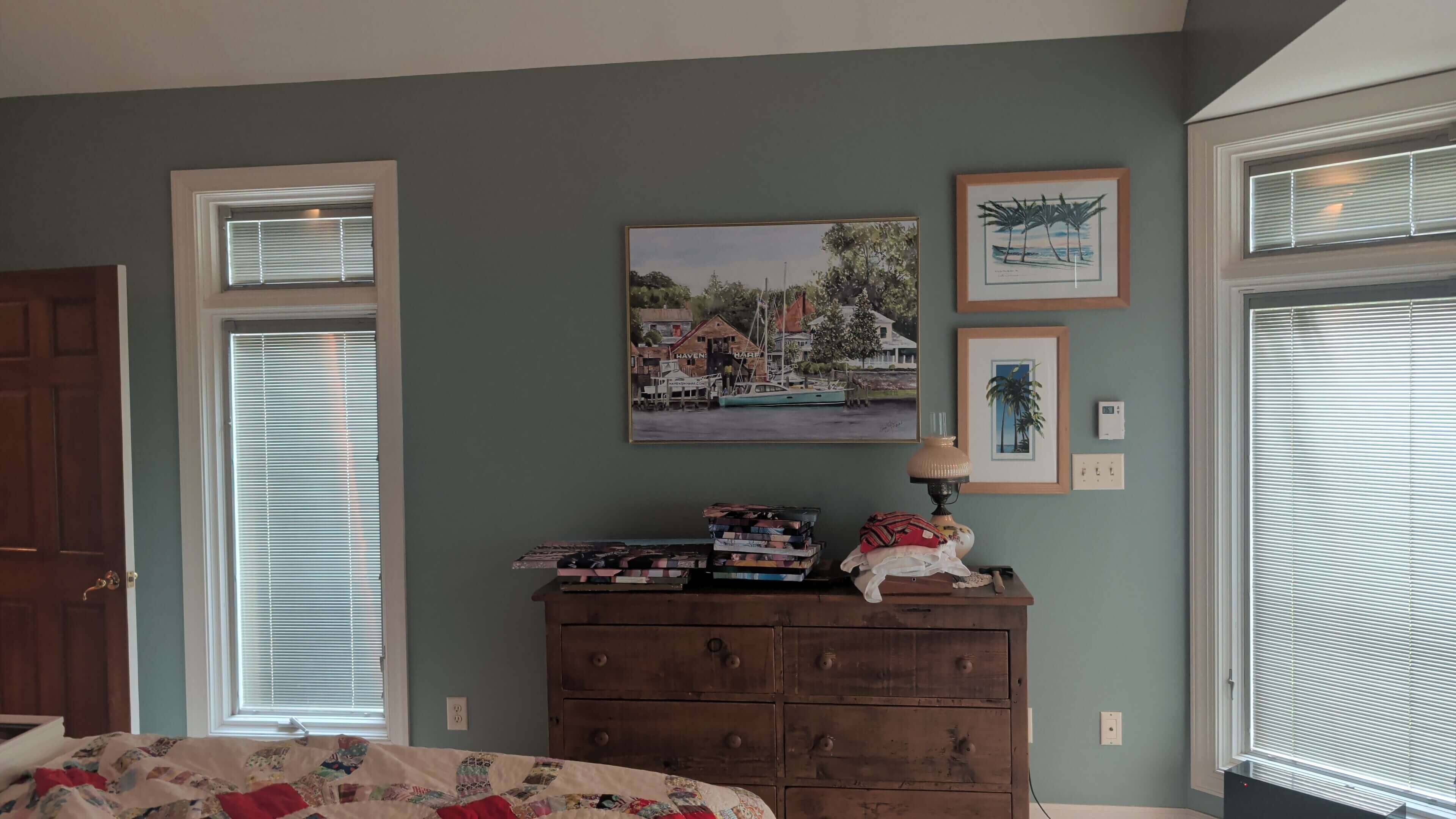 Painted bedroom with wood dresser and gallery wall
